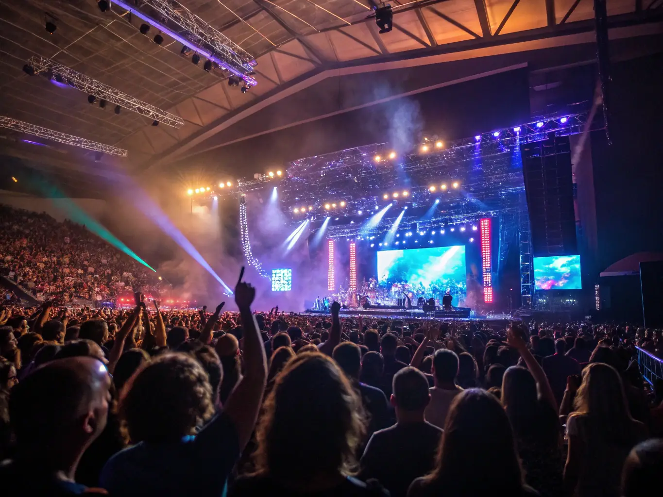 A vibrant image of a live concert with professional sound and lighting equipment, capturing the energy of a performance, showcasing IMPASSYSTEM's live performance support services.